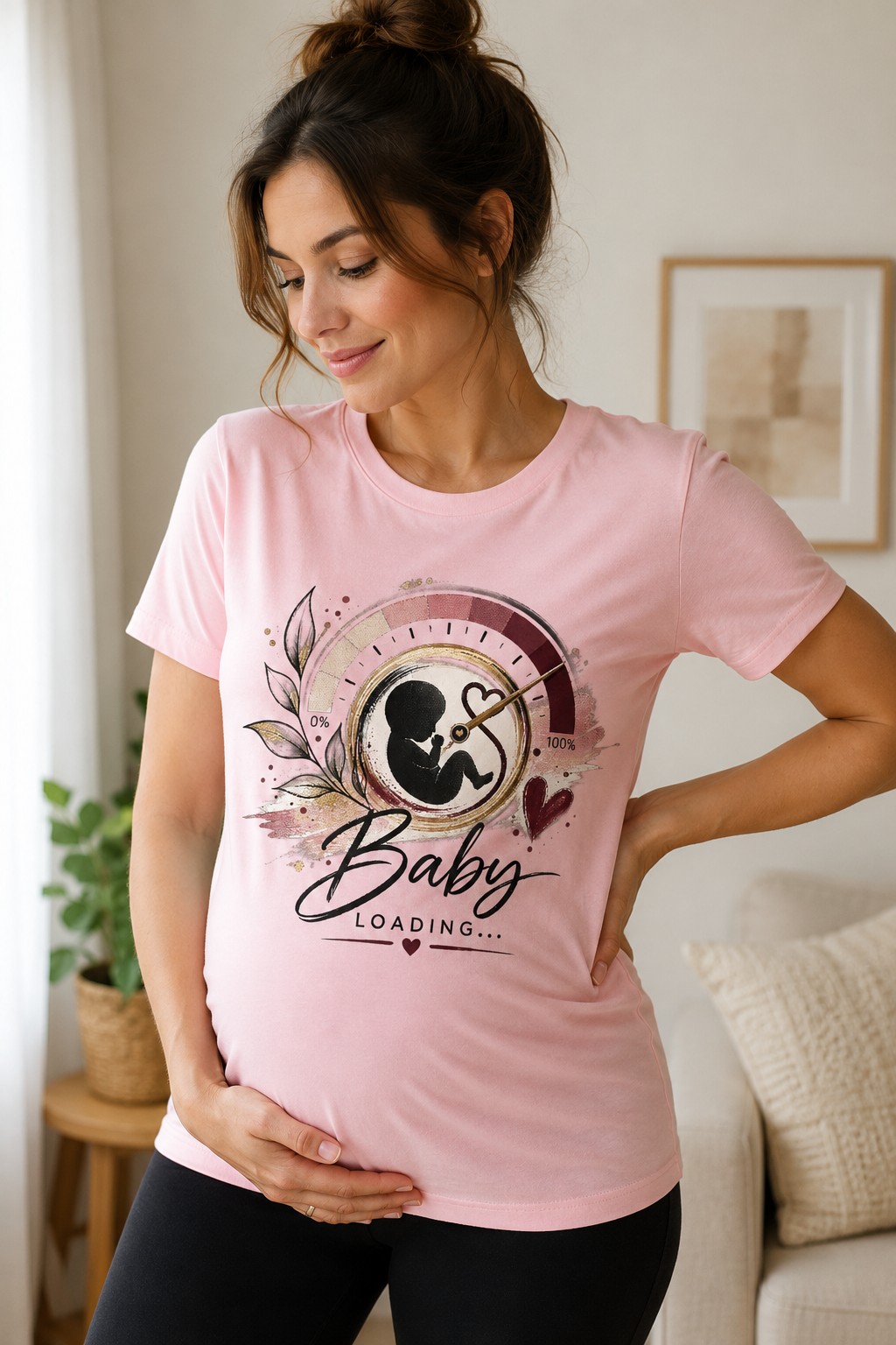 Pink women’s pregnancy announcement graphic T-shirt featuring a baby silhouette inside an artistic progress gauge with botanical details, burgundy and gold accents, and Baby Loading text.