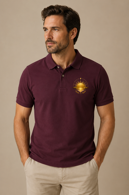 Man wearing a burgundy Earth Golden Horizon heritage graphic polo shirt with a golden sun and landscape chest design