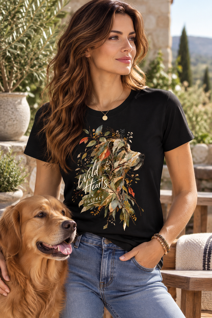 Woman wearing a black Wild Together dog graphic T-shirt featuring an artistic dog portrait, botanical leaves and Wild Hearts Run Together typography
