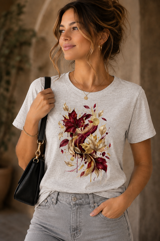 Woman wearing Autumn Colors seasonal graphic T-shirt with burgundy, gold and beige abstract autumn leaves